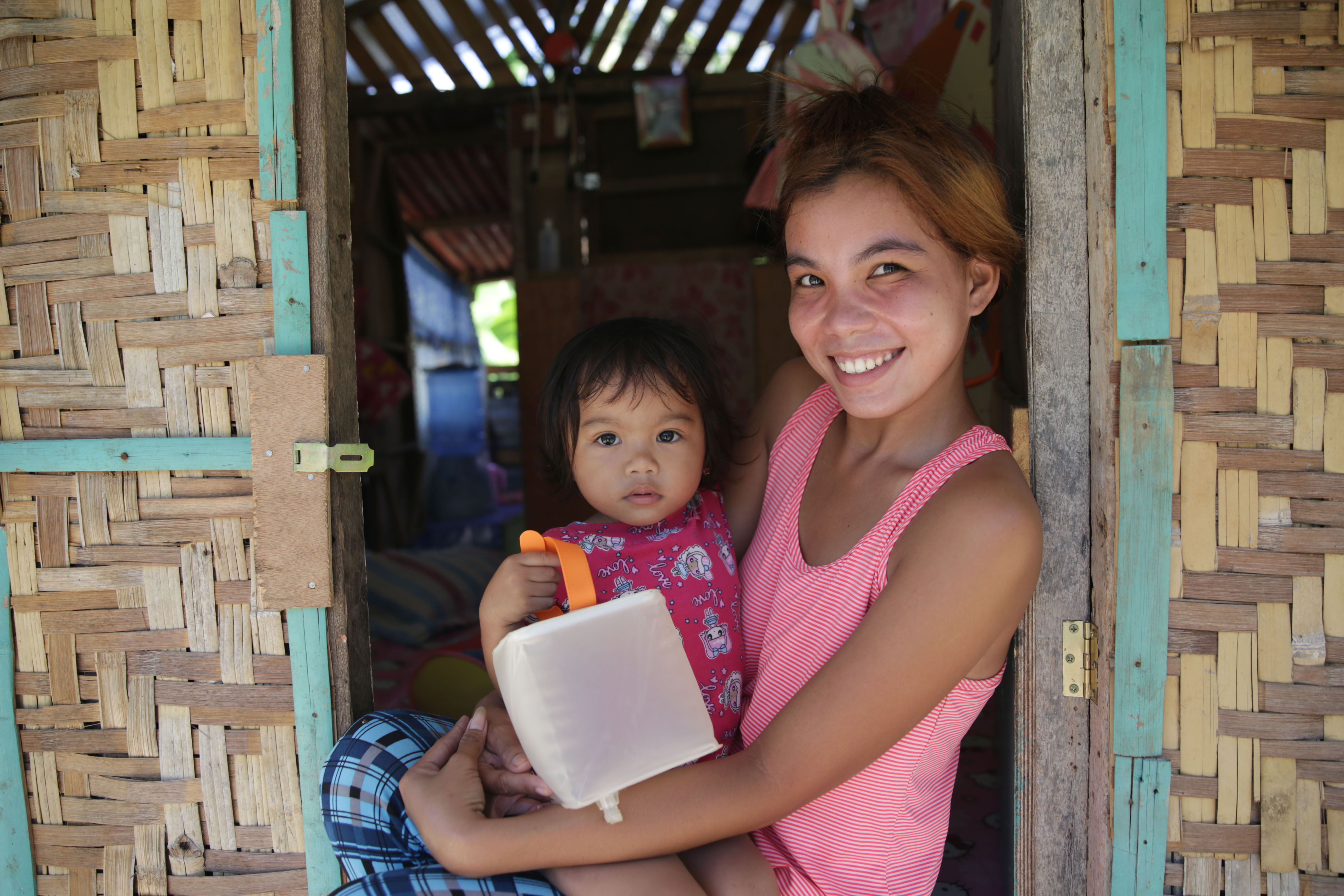 Young family receiving aid from ShelterBox