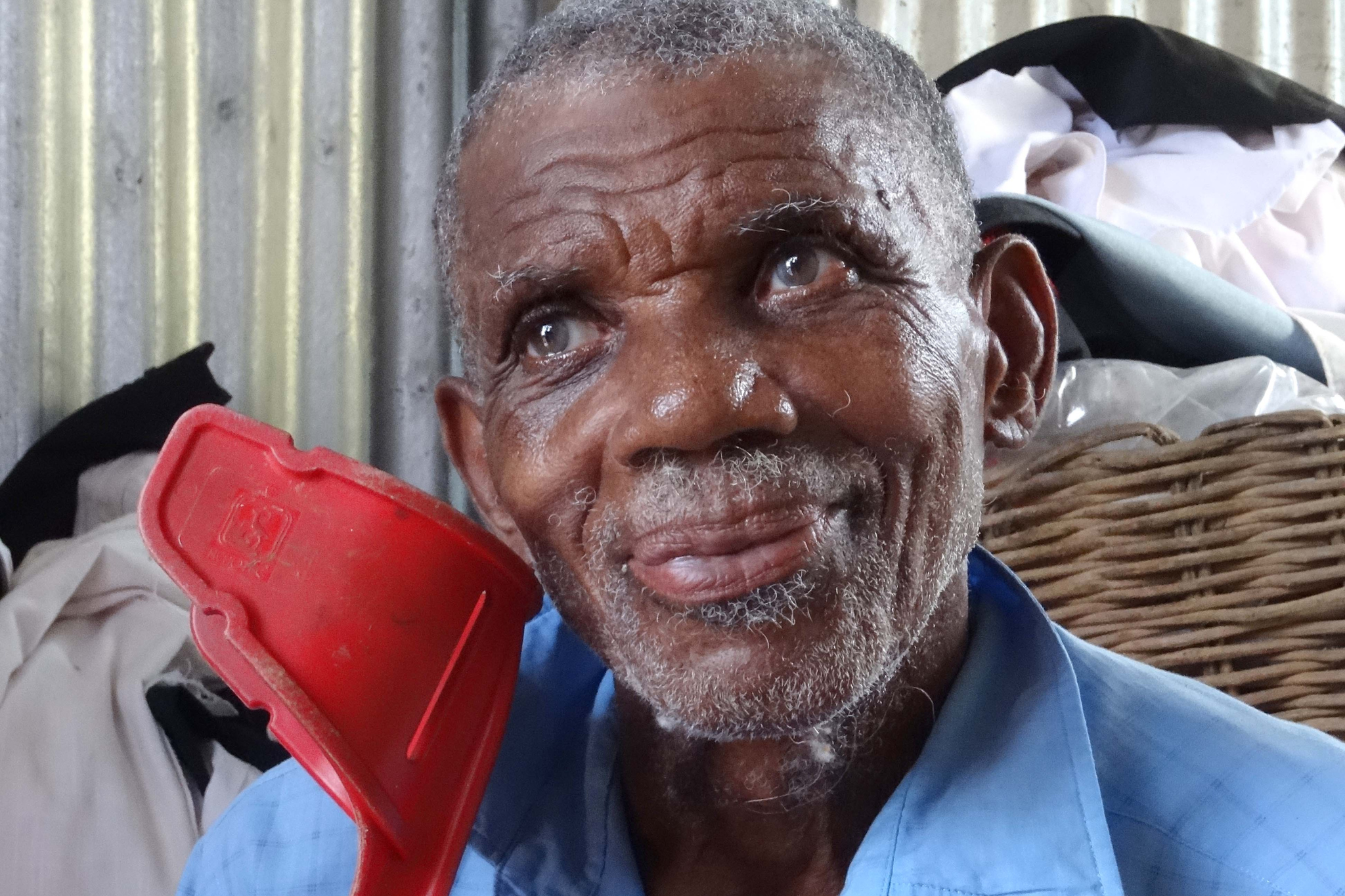 A man from Dominica receiving aid from ShelterBox